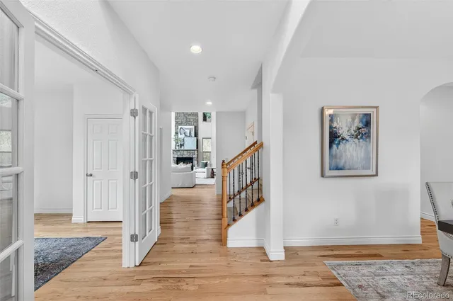a view of entryway and hall with wooden floor