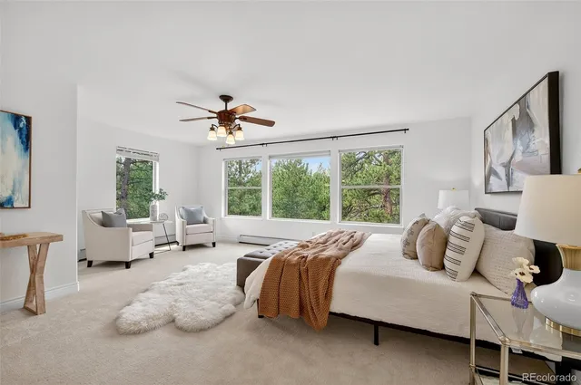 a bedroom with bed and a large window
