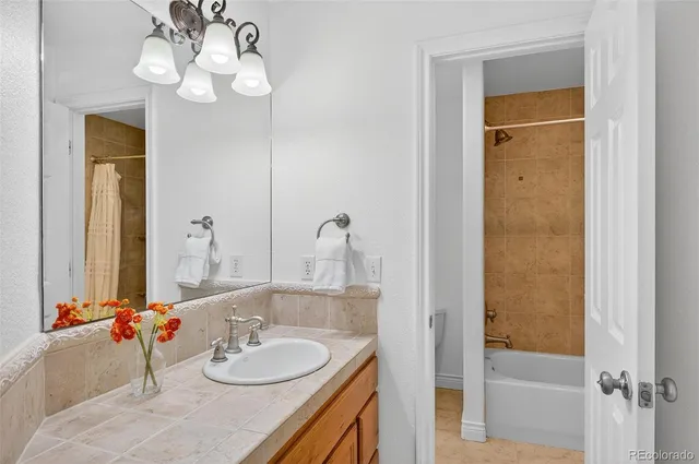a bathroom with a granite countertop sink and a mirror