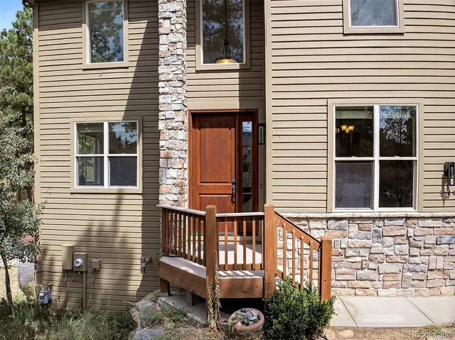 a view of a house with a window and wooden fence