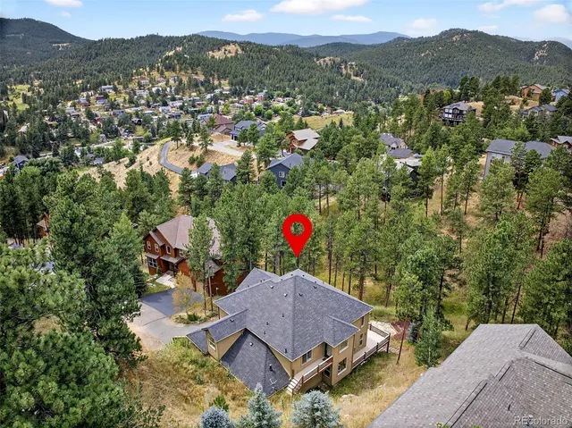 an aerial view of a house with a yard