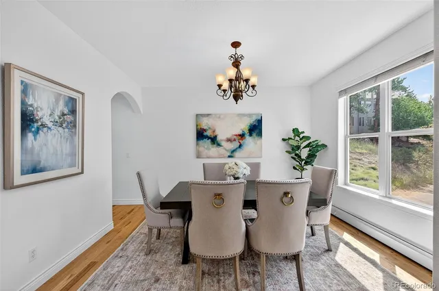 a dining room with furniture a rug and wooden floor