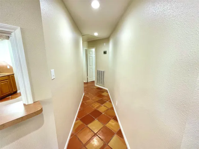 a view of hallway with wooden floor