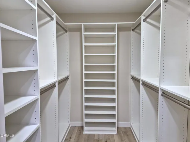 a view of walk in closet with empty racks