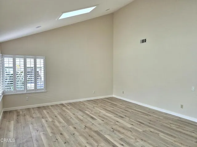 wooden floor in an empty room with a window