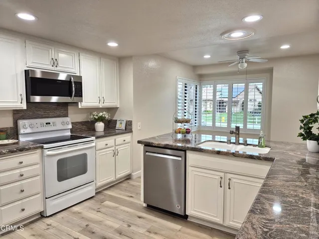 a kitchen with a sink stove and microwave