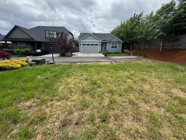 a front view of a houses with yard and green space
