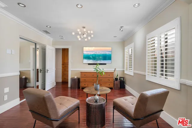 a living room with furniture a lamp and a large window