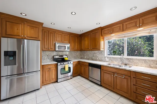 a kitchen with a sink appliances and cabinets