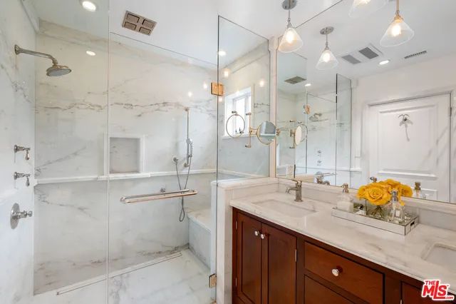 a bathroom with a granite countertop sink mirror and double