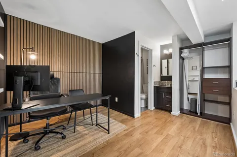 a view of a workspace with furniture and wooden floor