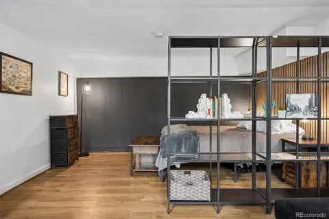 a bedroom with furniture and wooden floor
