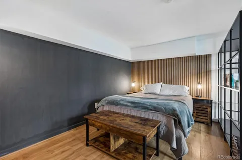 a bedroom with furniture and a wooden floor