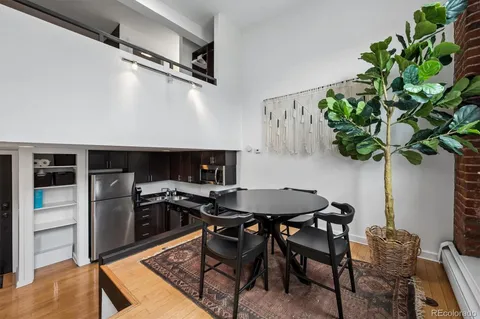 a view of a dining room with furniture and a potted plant