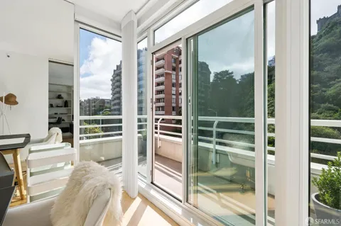 a view of a balcony with mountain view and wooden floor