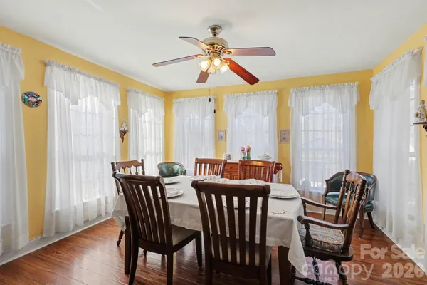 a view of a dining room with furniture window and wooden floor
