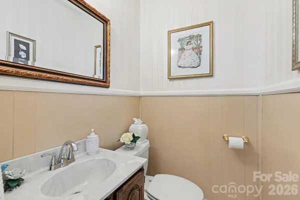 a bathroom with a sink mirror and toilet