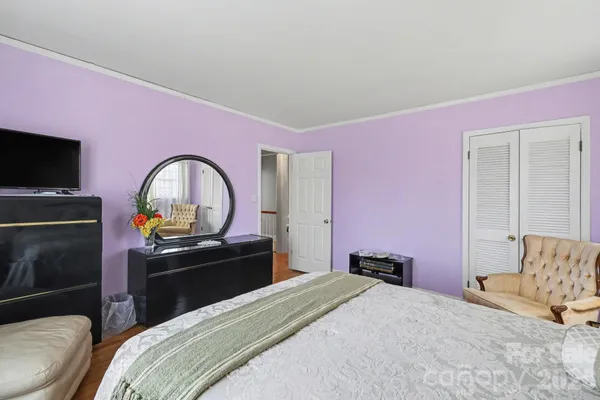 a bedroom with a bed and a flat screen tv