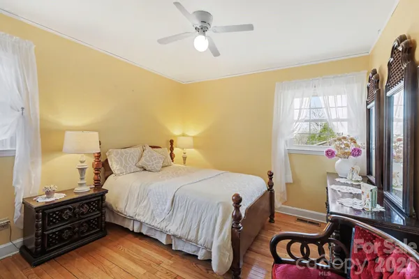 a bedroom with a bed and a dresser in it