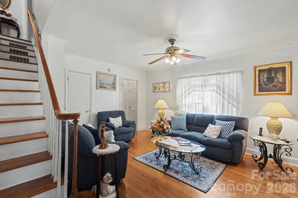 a living room with furniture and wooden floor
