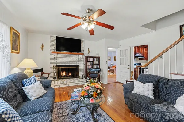 a living room with furniture fireplace and a flat screen tv