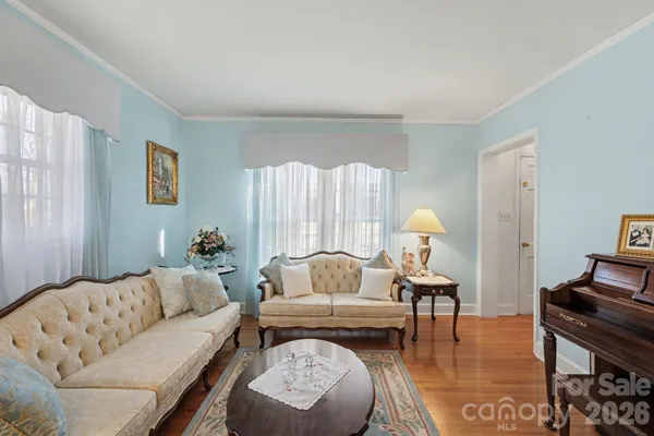 a living room with furniture and a lamp