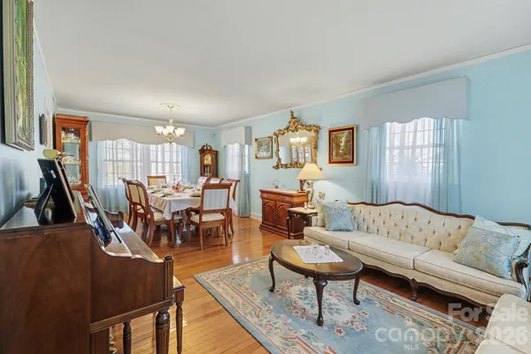 a living room with furniture wooden floor and a flat screen tv