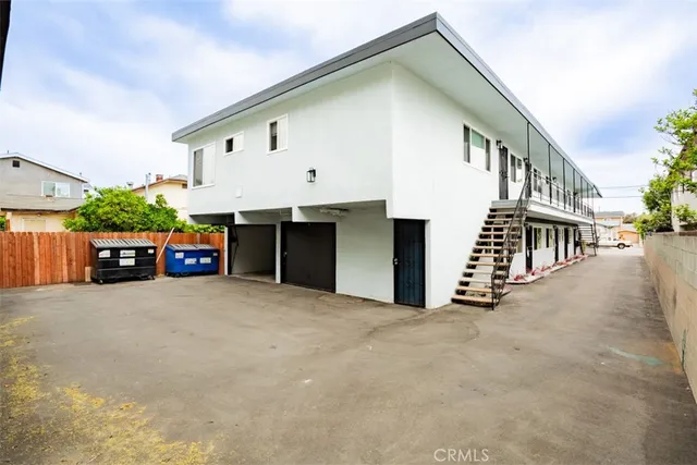 a view of a cars park in front of a building