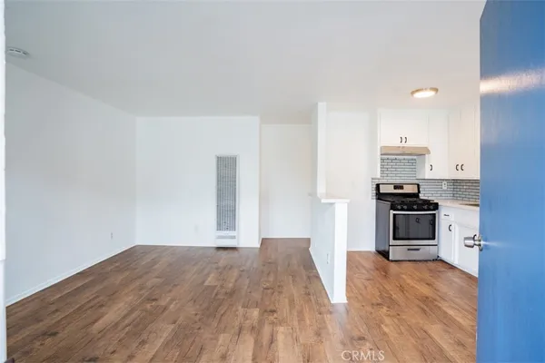 a kitchen with granite countertop a stove and a refrigerator