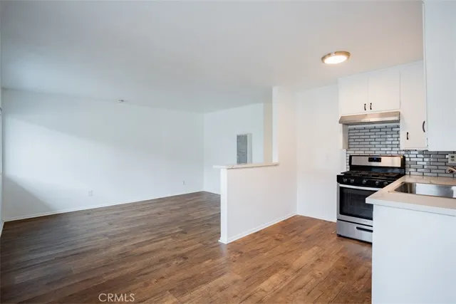 a kitchen with granite countertop a stove and a sink