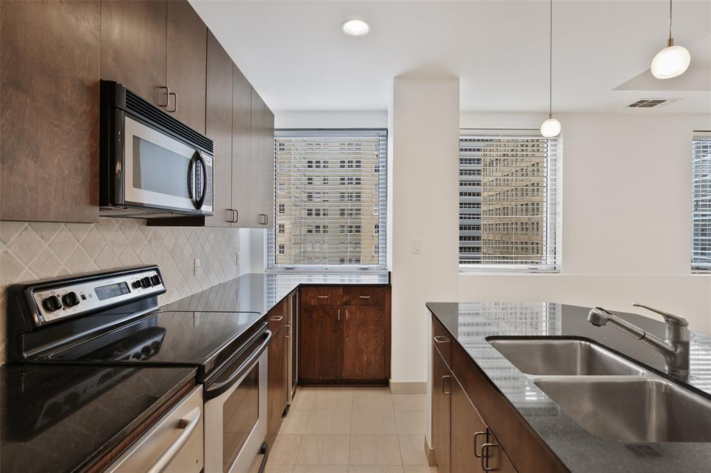 a kitchen that has a sink and a stove