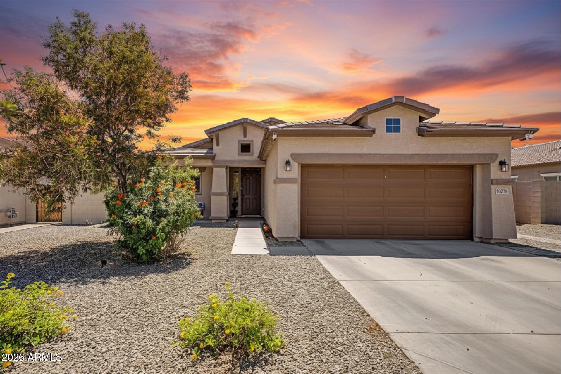 16719 West Rowel Road Surprise, AZ 85387 - Photo 1 of 28 a front view of a house with a yard and garage
