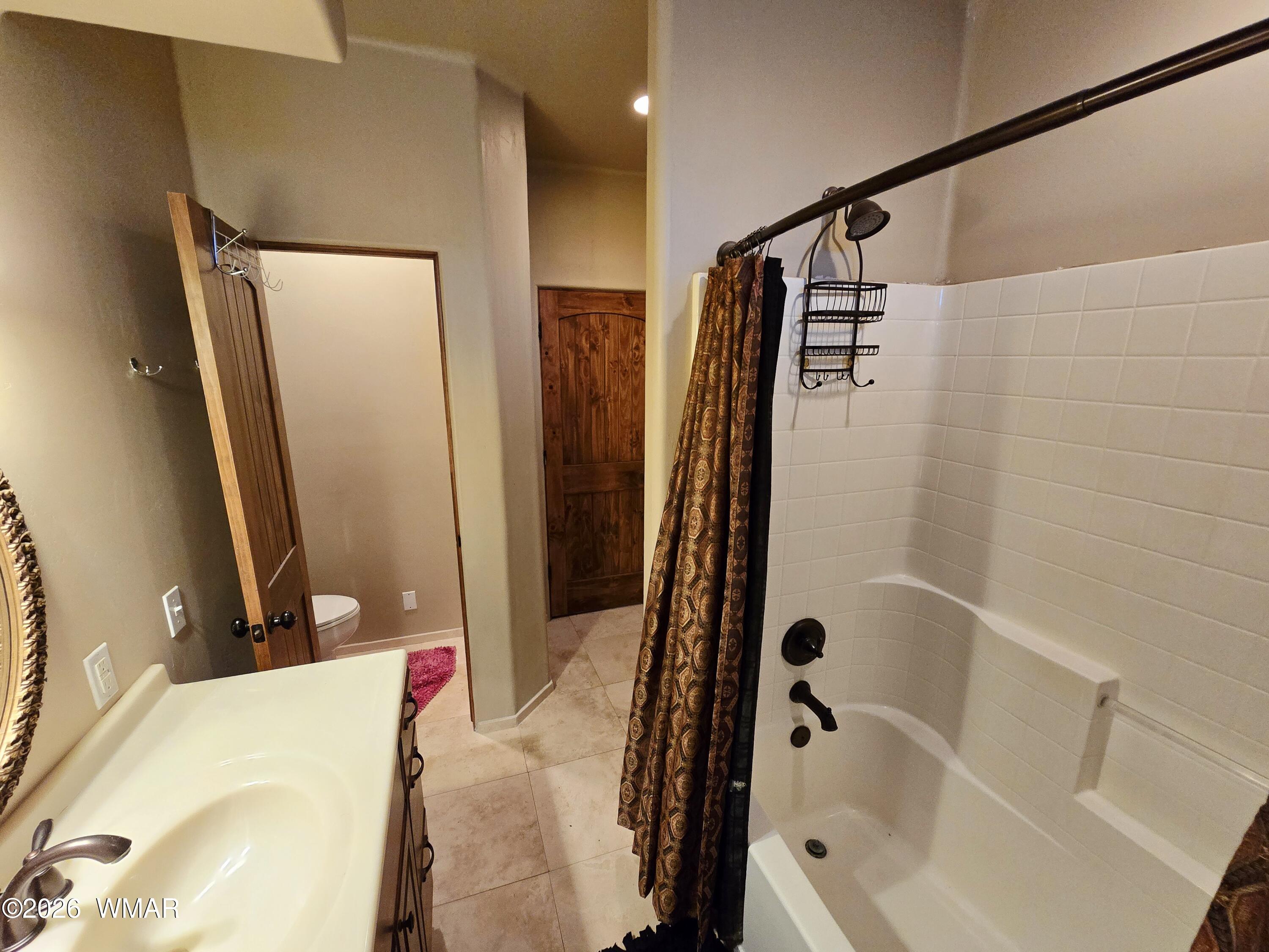 9046 Miller Trail Snowflake, AZ 85937 - Photo 23 of 34 a bathroom with a tub and a shower