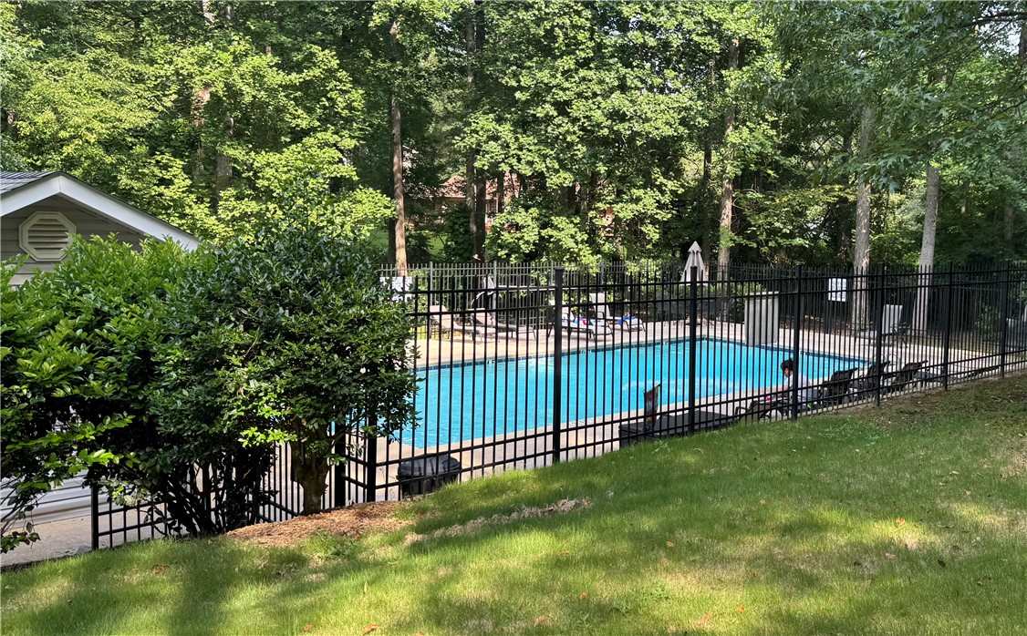 110 Brookstone Way Central, SC 29630 - Photo 45 of 46 This serene outdoor oasis features a refreshing pool, perfect for relaxation and recreation amidst lush greenery.