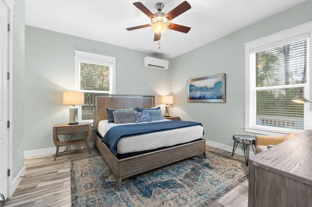 a bedroom with a bed a window and a flat screen television