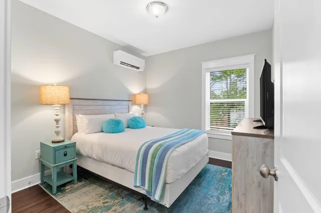 a bedroom with a bed and a flat screen tv