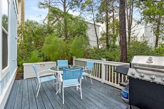 a view of a deck with a table chairs and wooden floor