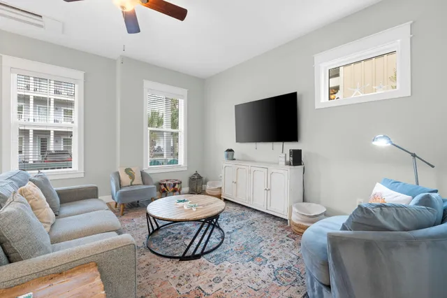 a living room with furniture a rug and a large window