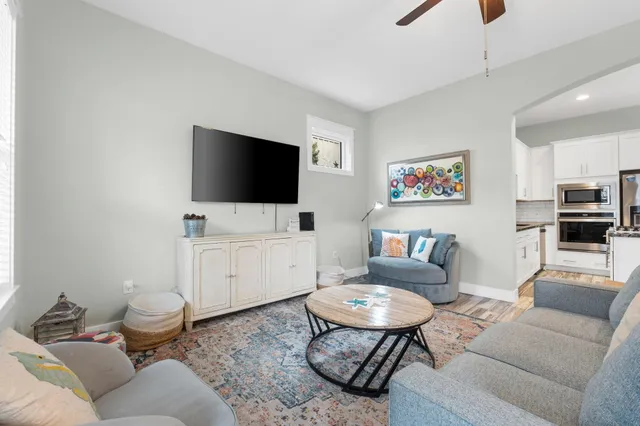 a kitchen with granite countertop a sink stove and refrigerator