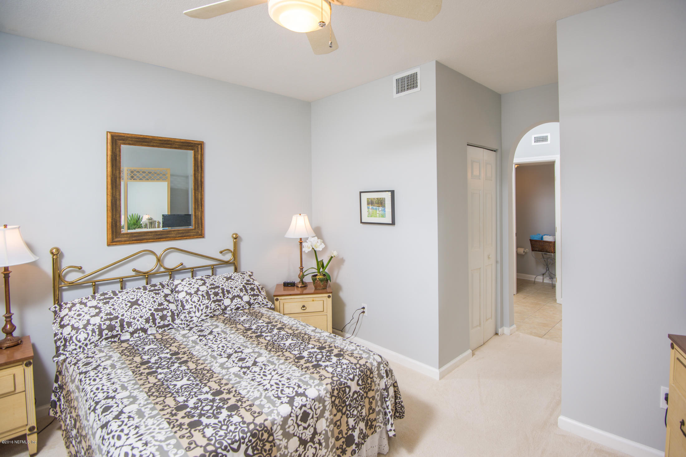 3210 Haley Pointe Road St. Augustine, FL 32084 - Photo 21 of 44 a bedroom with a bed and a chandelier