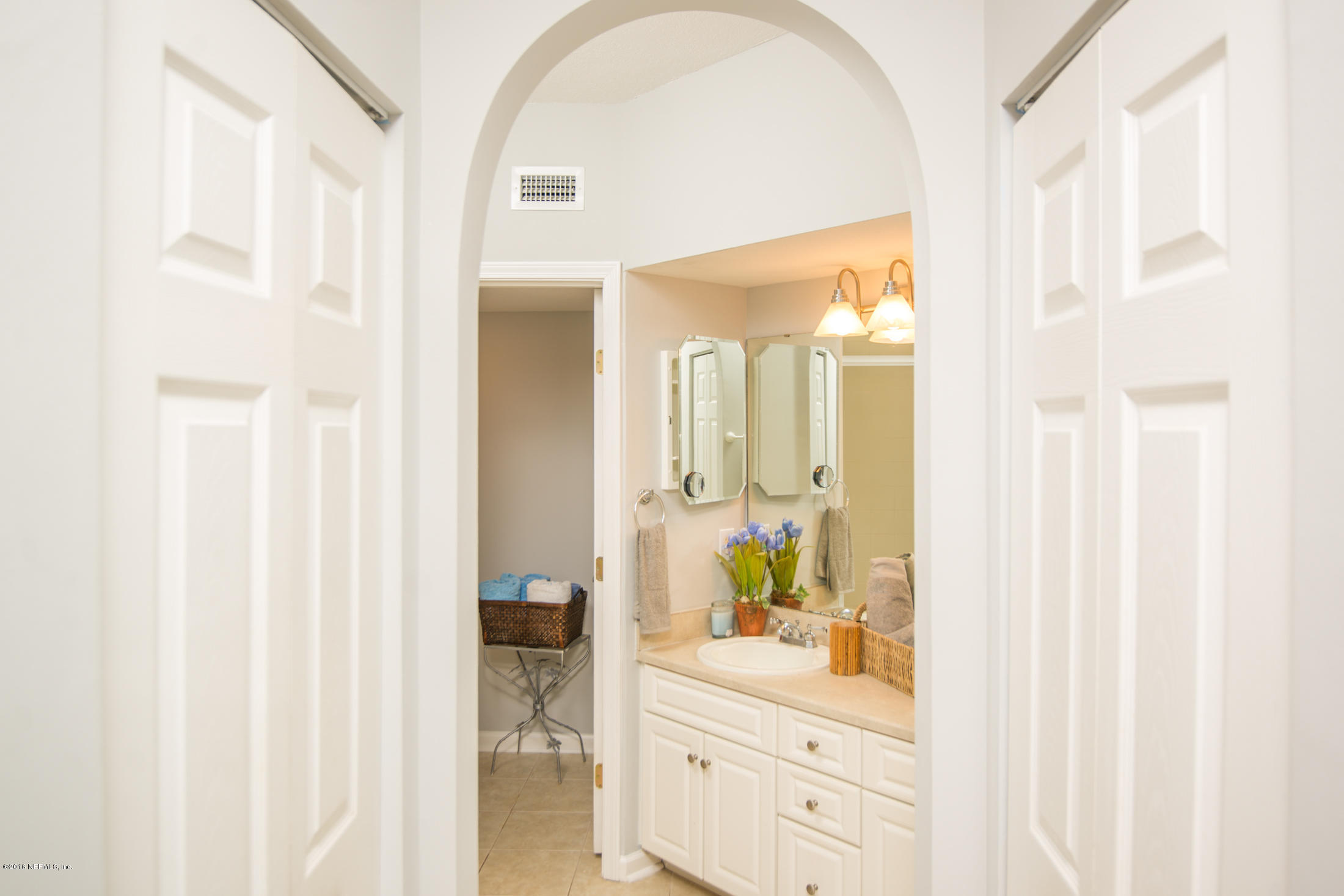 3210 Haley Pointe Road St. Augustine, FL 32084 - Photo 24 of 44 a bathroom with a sink mirror and vanity