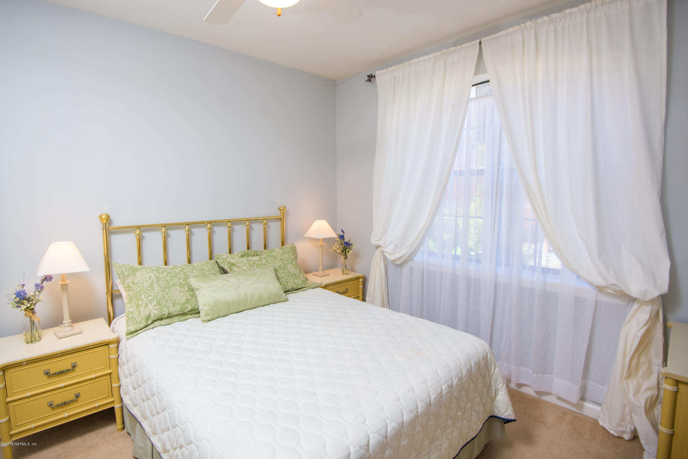 3210 Haley Pointe Road St. Augustine, FL 32084 - Photo 29 of 44 a bed sitting in a bedroom next to a window