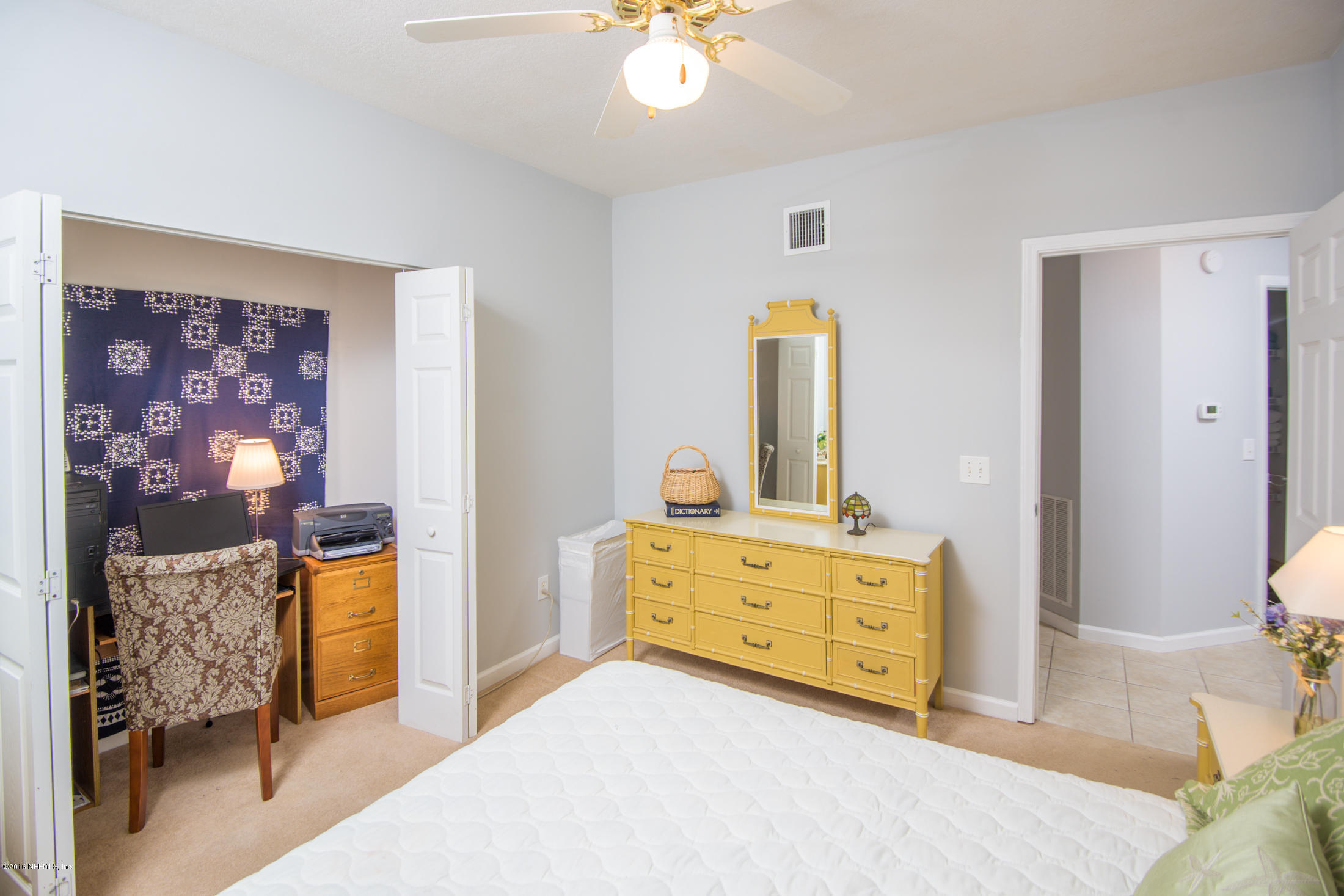 3210 Haley Pointe Road St. Augustine, FL 32084 - Photo 30 of 44 a bedroom with a bed and a dresser in it