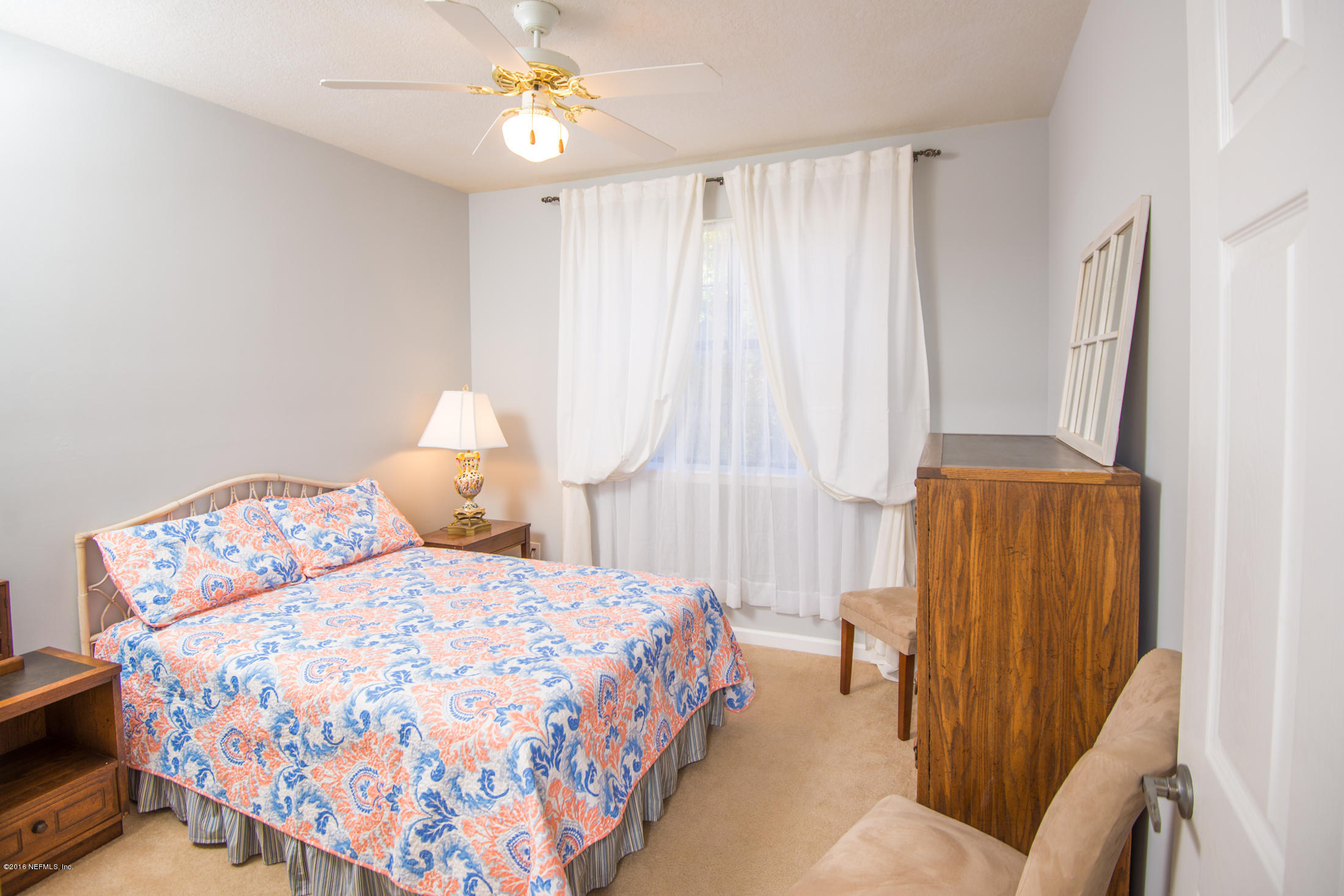 3210 Haley Pointe Road St. Augustine, FL 32084 - Photo 31 of 44 a bedroom with a bed and a chandelier