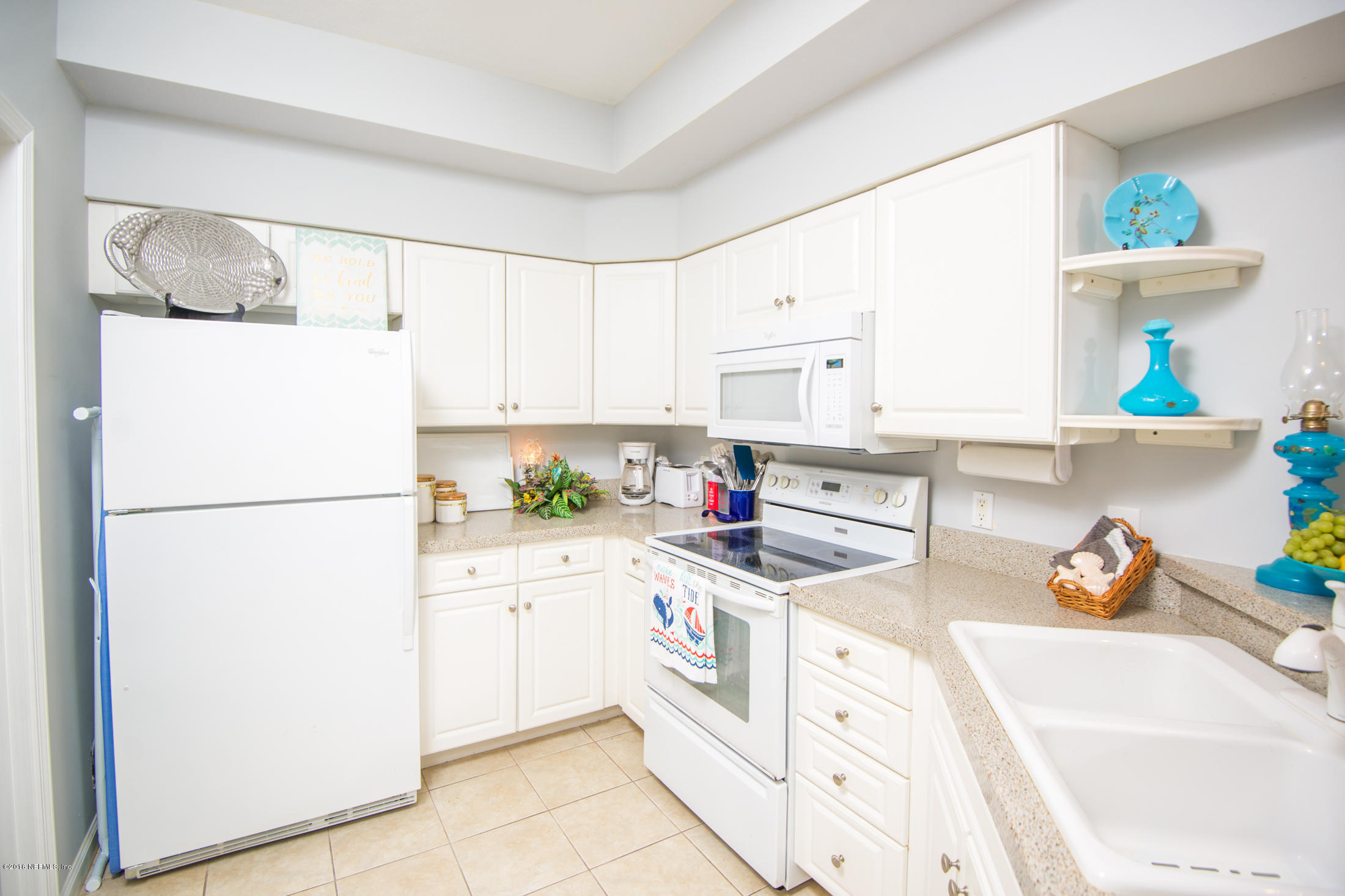 3210 Haley Pointe Road St. Augustine, FL 32084 - Photo 4 of 44 a kitchen with white cabinets and white appliances
