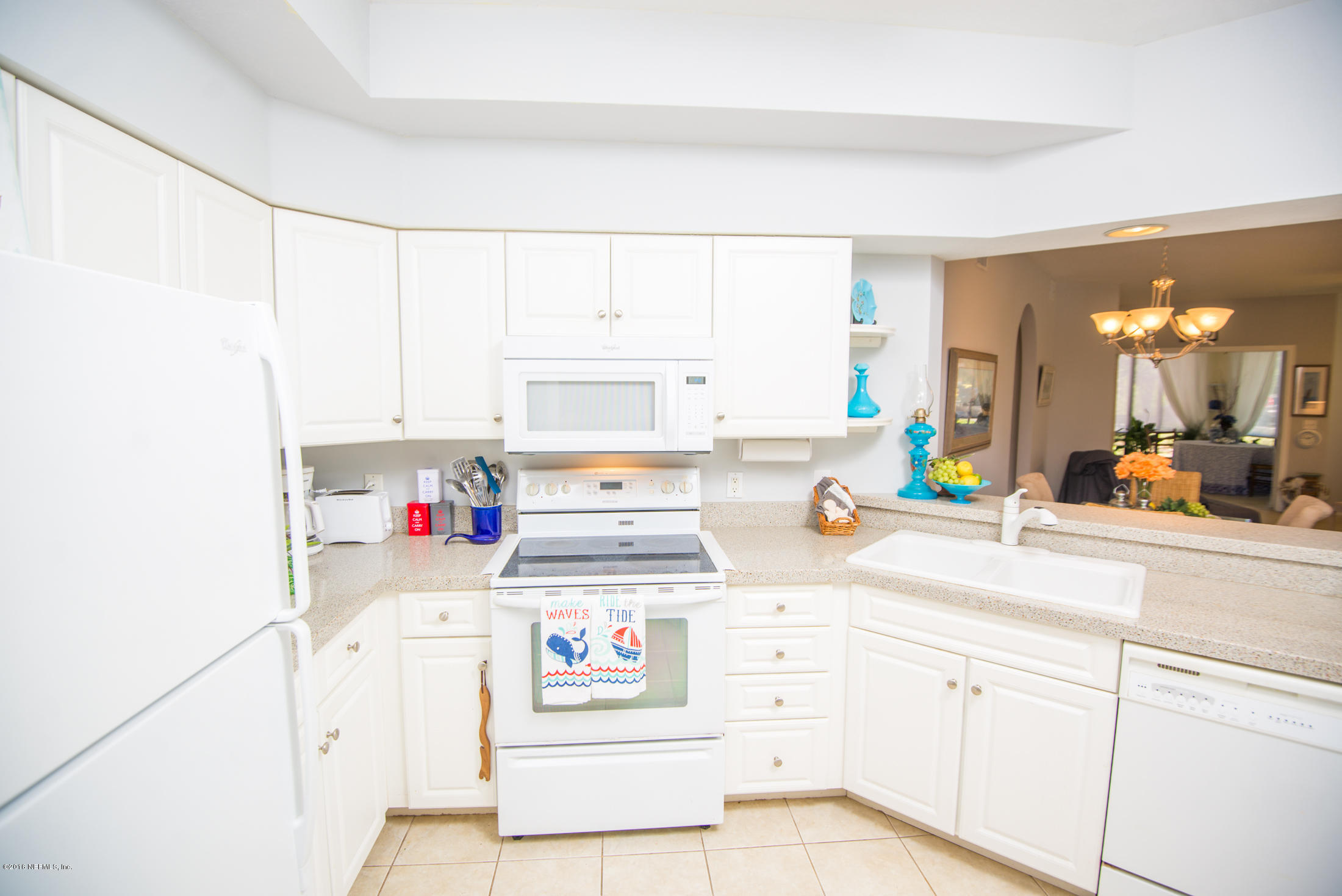 3210 Haley Pointe Road St. Augustine, FL 32084 - Photo 6 of 44 a kitchen with kitchen island white cabinets and appliances