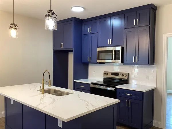 a kitchen with wooden cabinets and stainless steel appliances