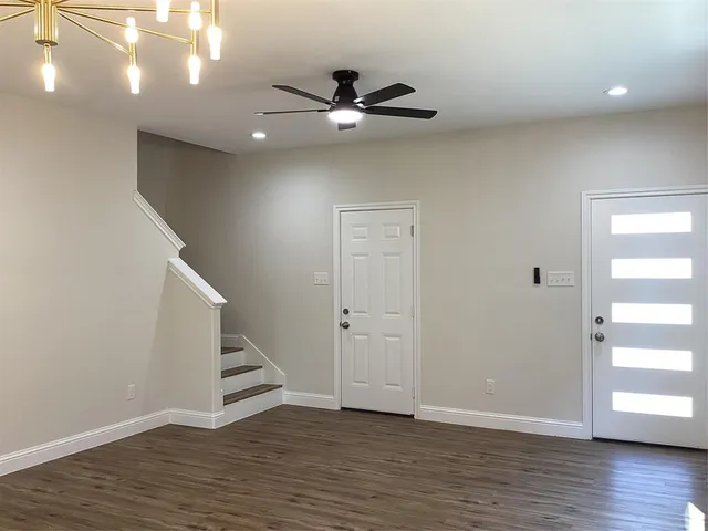 a view of an entryway with wooden floor