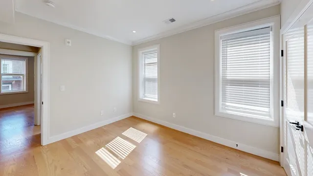 a view of wooden floor and windows in a room