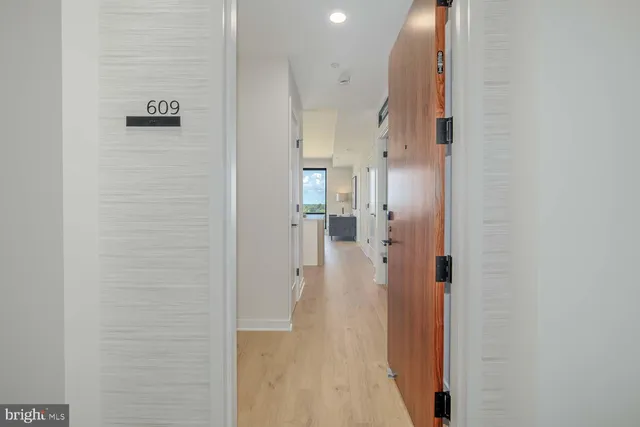 a view of a hallway with a cabinet and a mirror